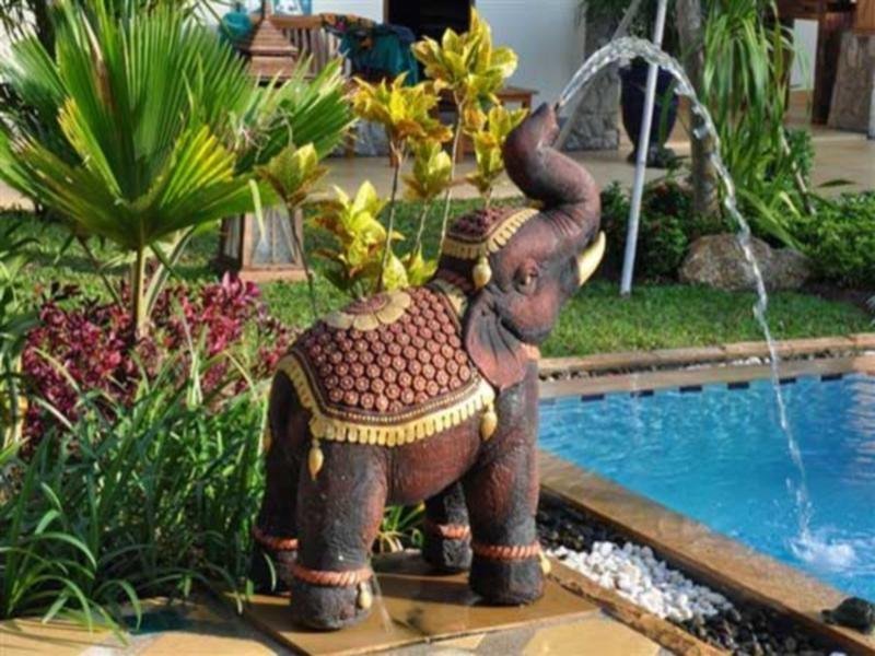Decorative elephant fountain beside the pool at Baan Malinee