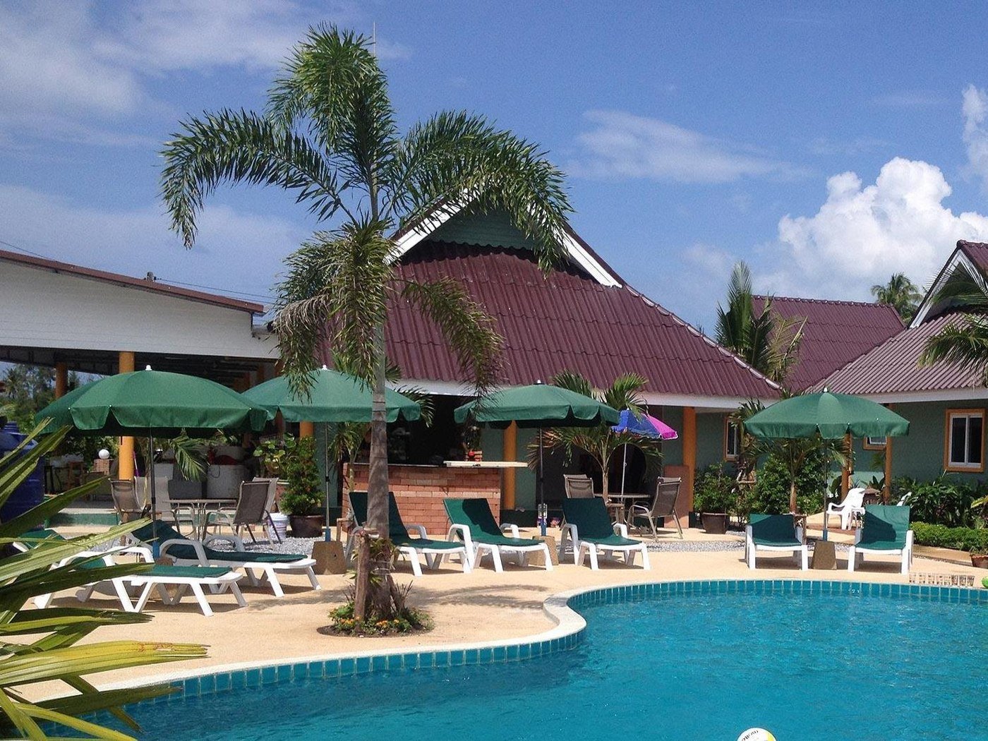 Shared pool and sun loungers at Coconut Homes Khao Lak