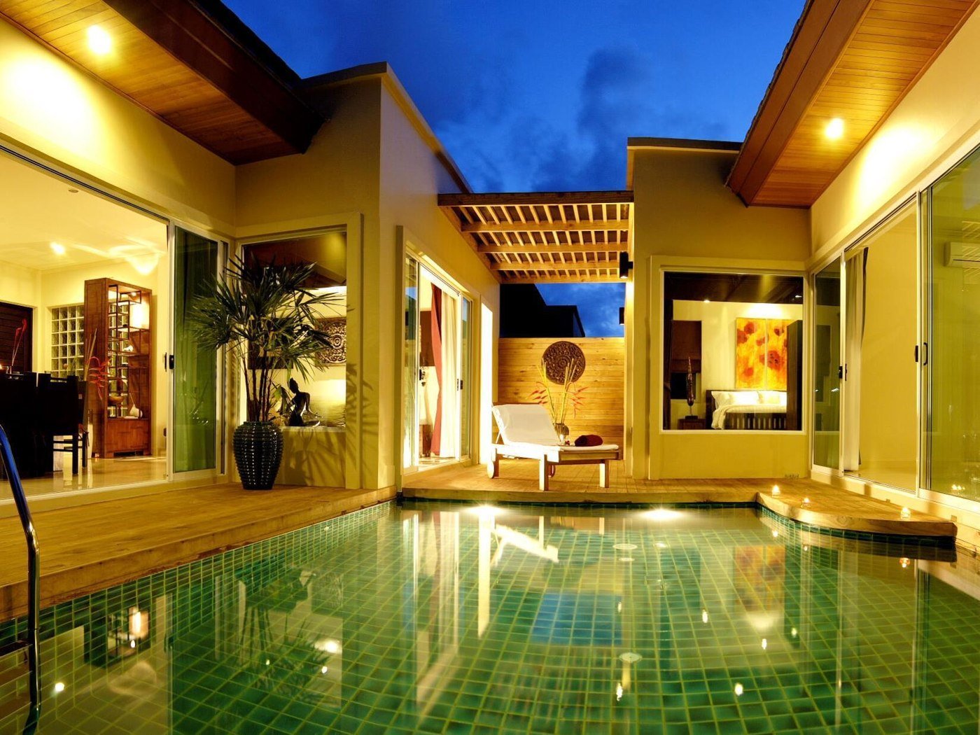 Illuminated courtyard pool between villa buildings at Karon Beach Walk Villa