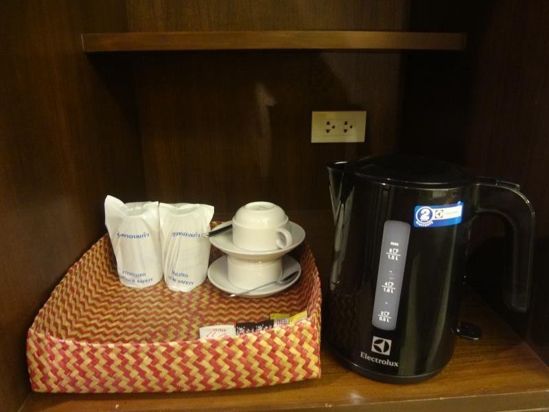 Kettle, cups and drinking glasses on a shelf at Lanta For Rest Boutique Hotel