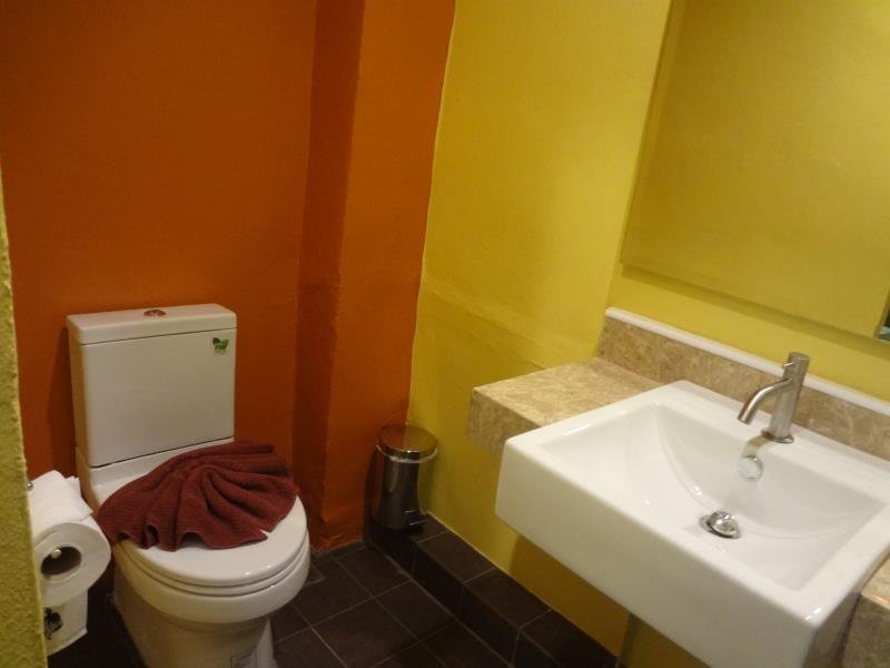 Bathroom with a white basin and toilet at Lanta For Rest Boutique Hotel