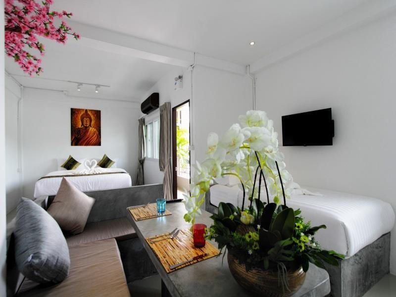 Bright bedroom and sitting area at Samui Beach Residence Hotel