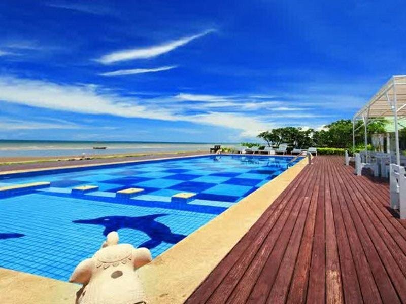 Sea-facing swimming pool beside a wooden deck at Sea Sky Resort