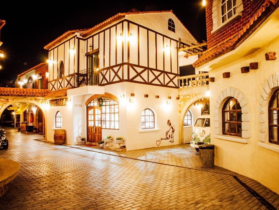 Illuminated timber-style facade and courtyard at Swiss Hotel Pattaya