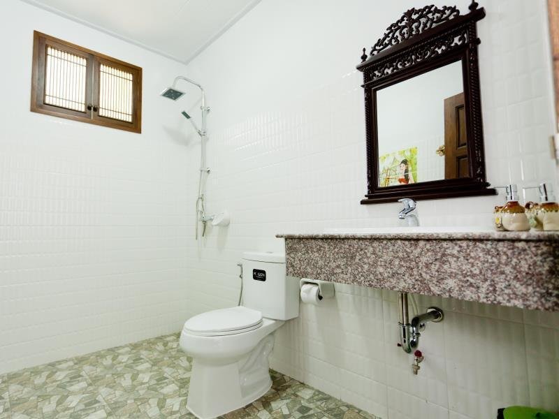 Bathroom with shower, basin and carved mirror at The Mouth Resort