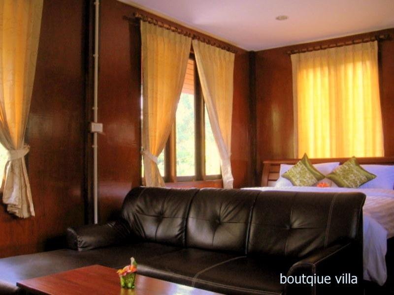 Bedroom and sofa at The Theatre Villa